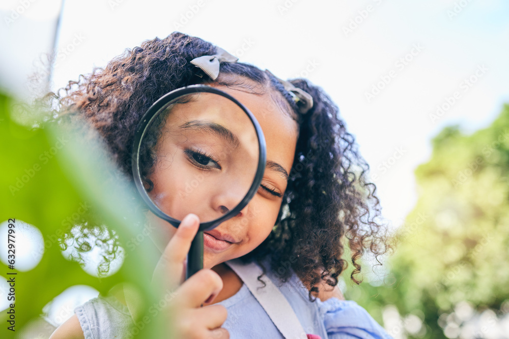 Girl child, magnifying glass and leaves in garden, backyard or park in science, study or outdoor. Yo