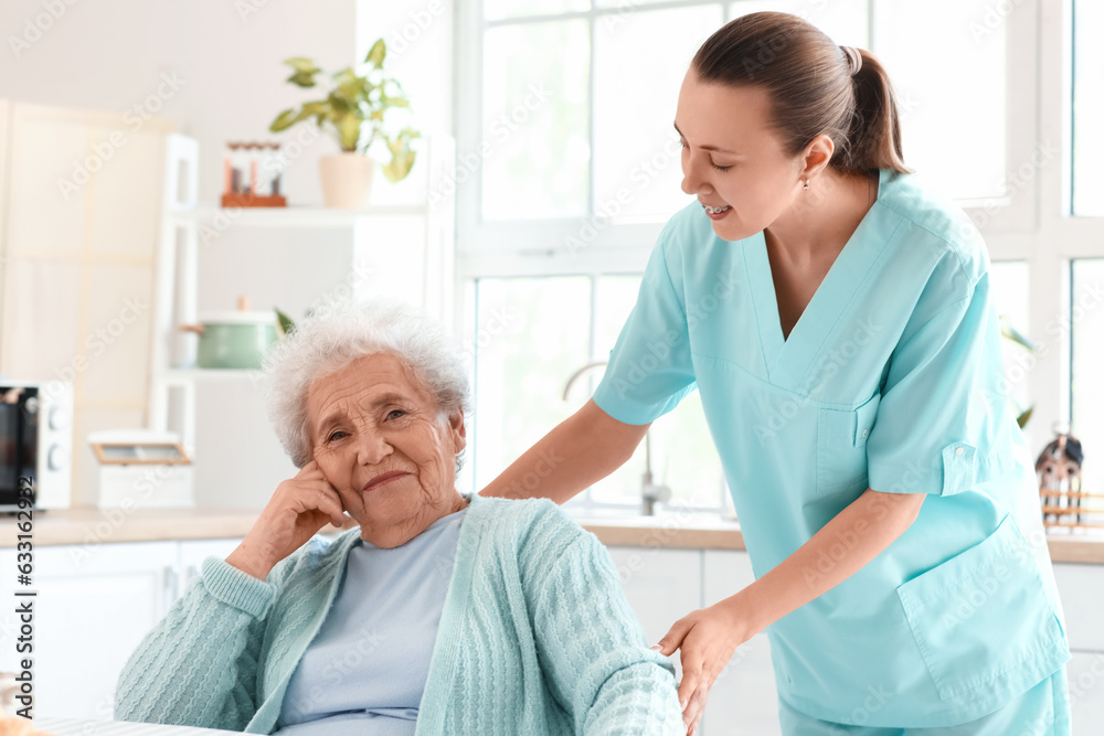 Senior woman with female caregiver in kitchen