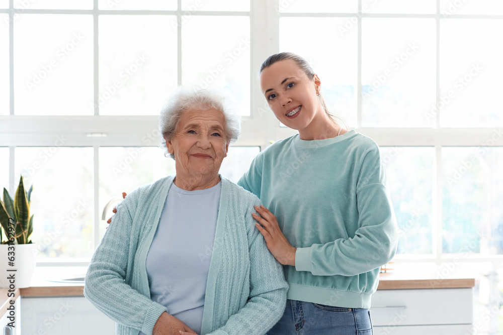 Senior woman with her granddaughter in kitchen