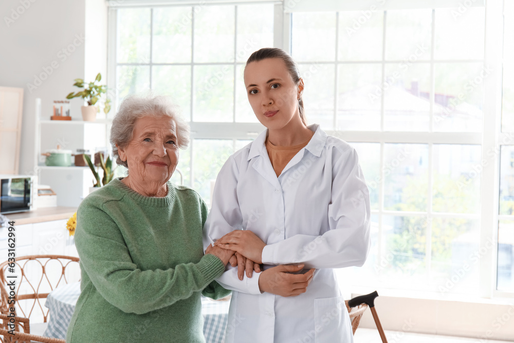 Senior woman with female doctor in kitchen