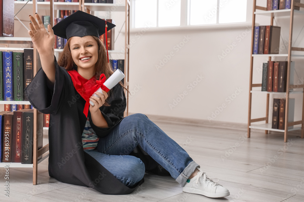 Female graduate student with diploma in library