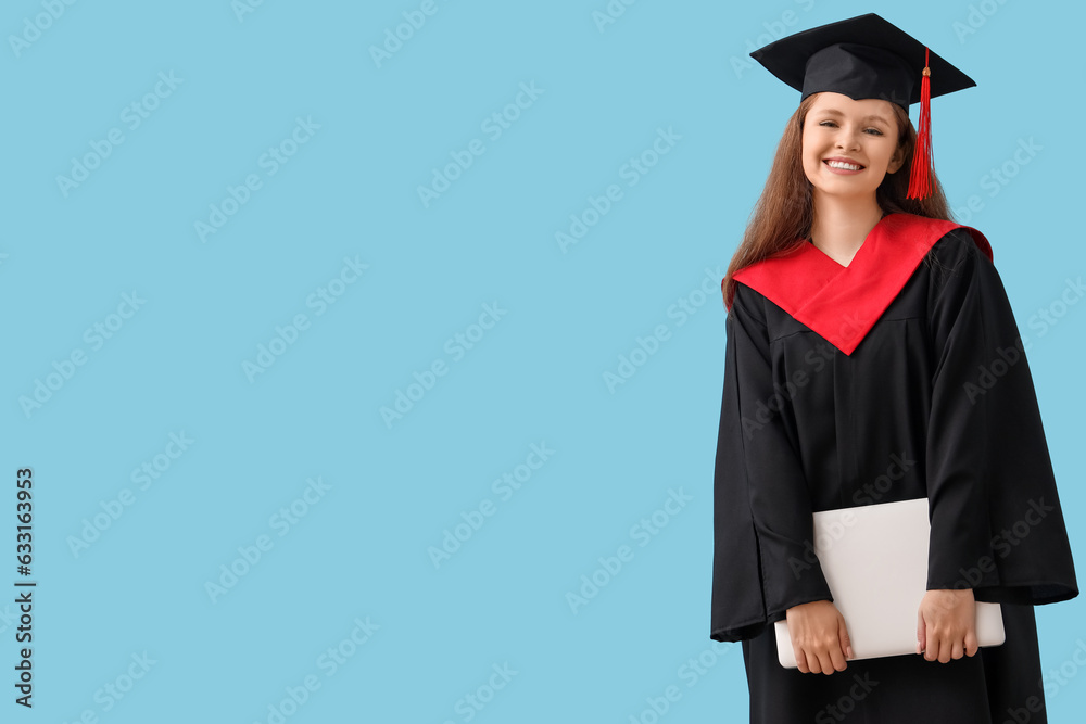 Female graduate student with laptop on blue background