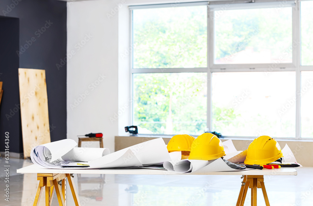 Table with builders equipment in room