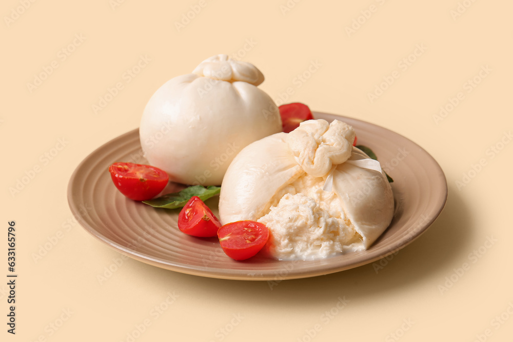 Plate with tasty Burrata cheese on yellow background