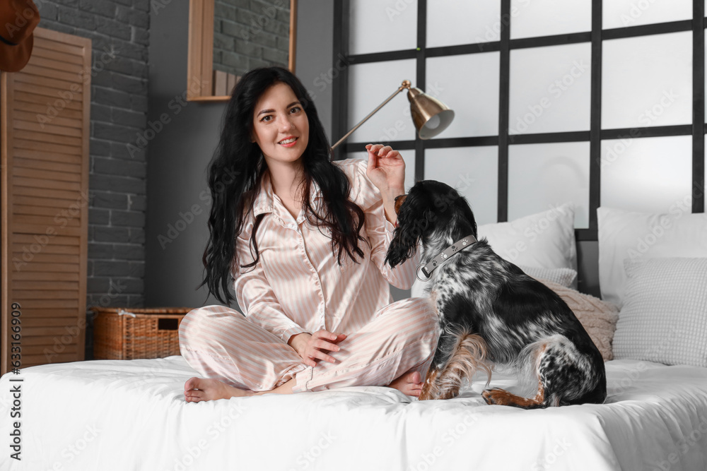 Young woman with cute dogs in bedroom