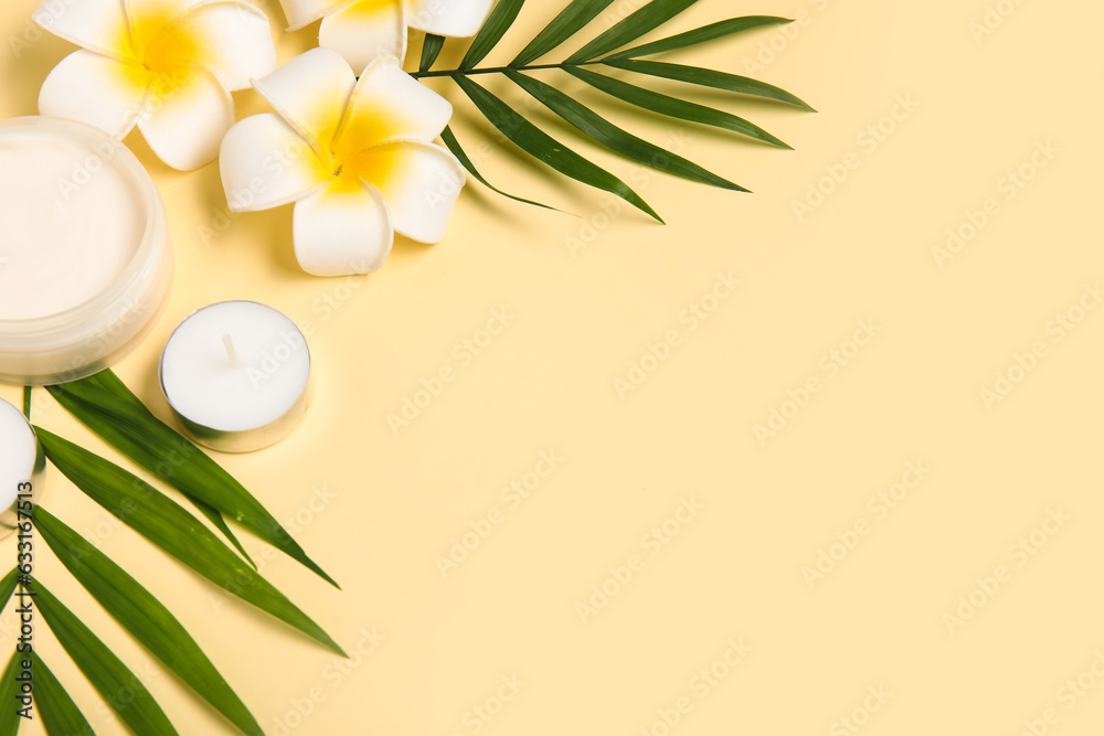 Composition with jar of cream, candle, palm leaves and flowers on color background