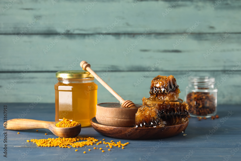 Sweet honey, combs and bee pollen on table