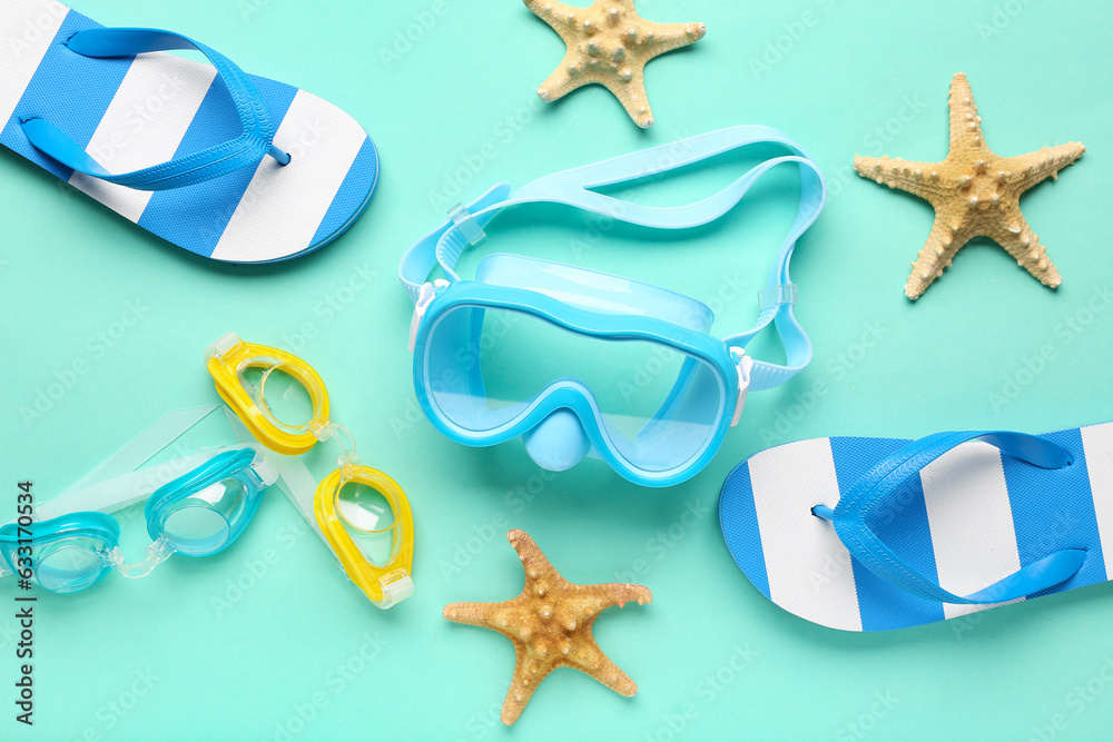 Composition with snorkeling mask, goggles, flip-flops and starfishes on color background