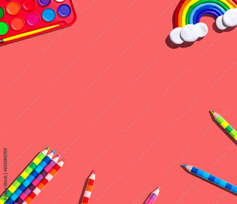 Art supplies with a rainbow - overhead view - flat lay