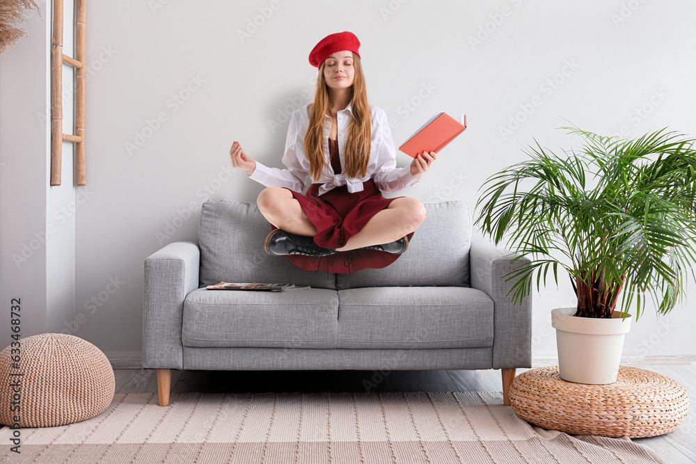 Interior of light modern living room with sofa, pouf and houseplant