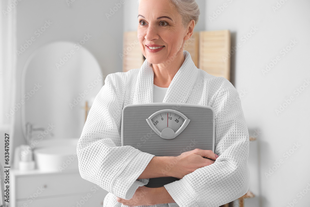 Mature woman with scales in bathroom