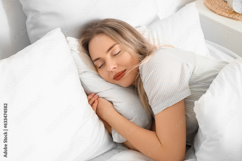 Young woman sleeping in bed