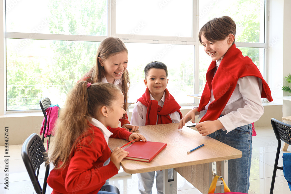 Happy little pupils in classroom