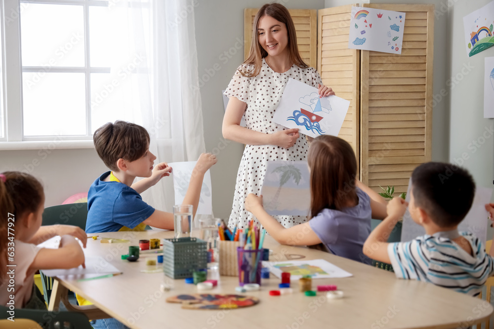 Little pupils with teacher in art class