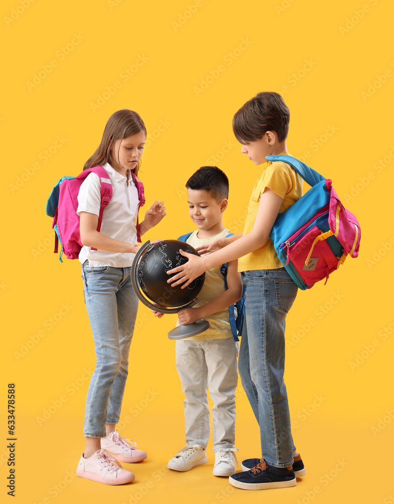 Little pupils with globe on yellow background