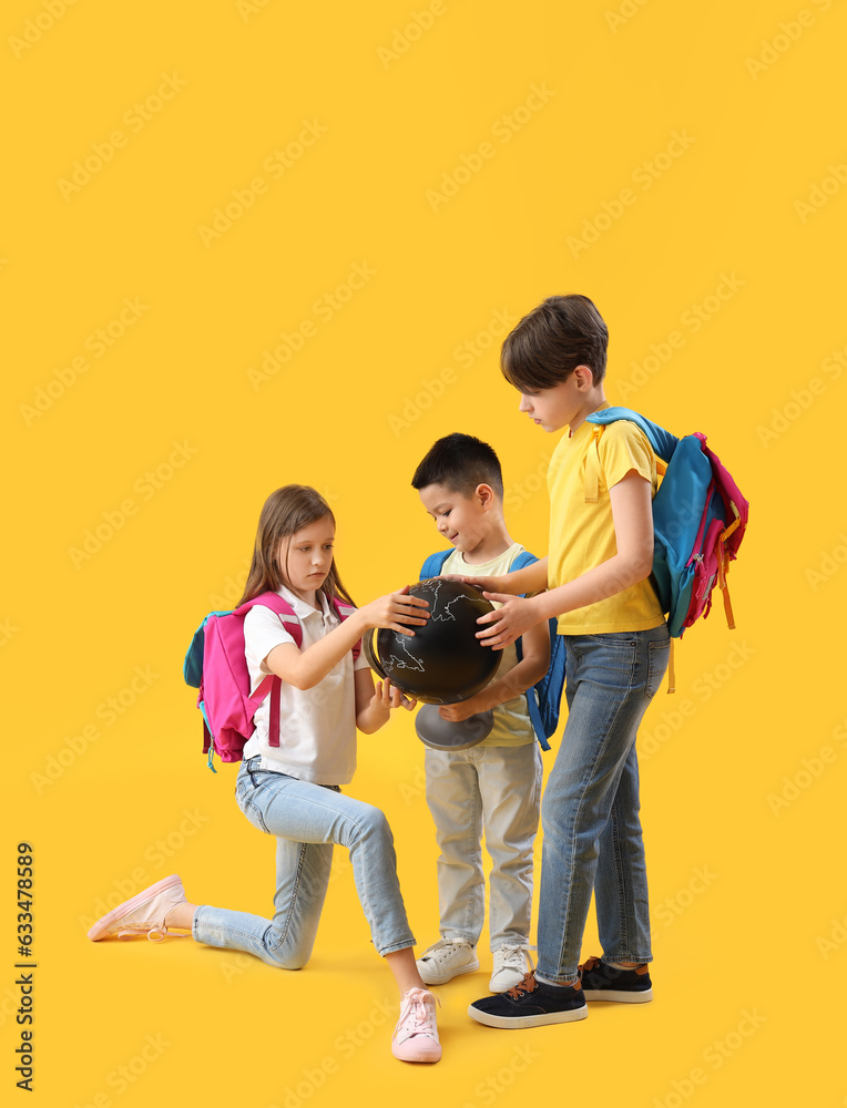 Little pupils with globe on yellow background