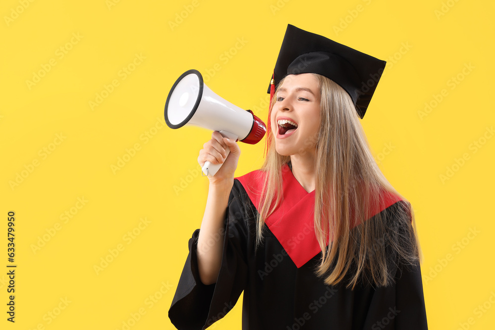 Female graduate student shouting into megaphone on yellow background