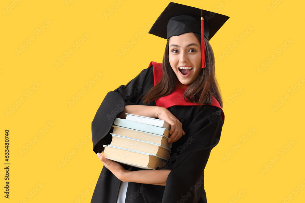 Female graduate student with books on yellow background