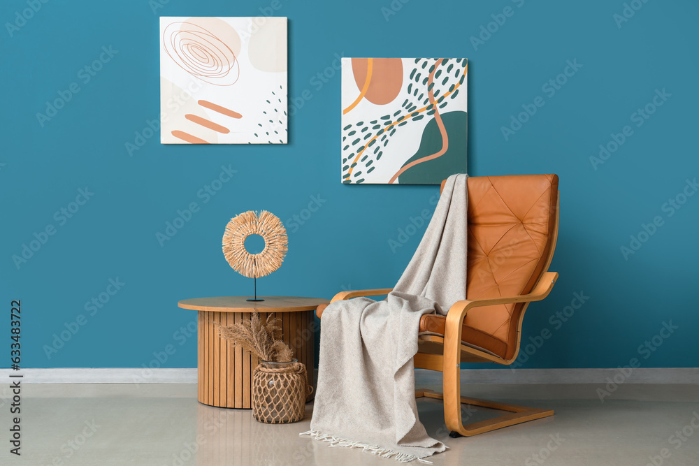 Interior of living room with plaid on armchair and table