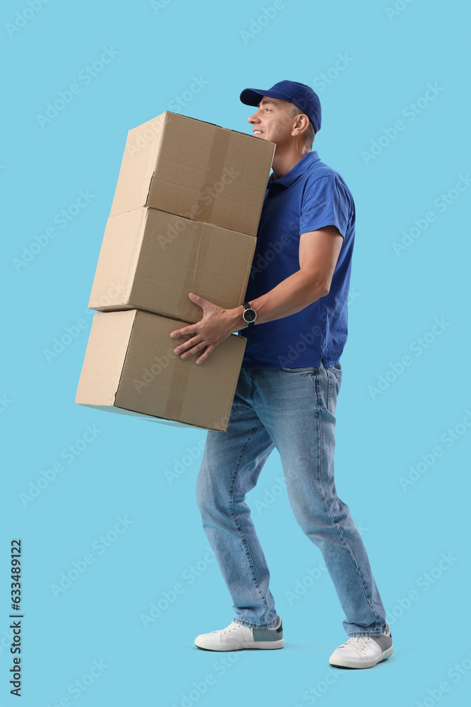 Mature courier with parcels on blue background