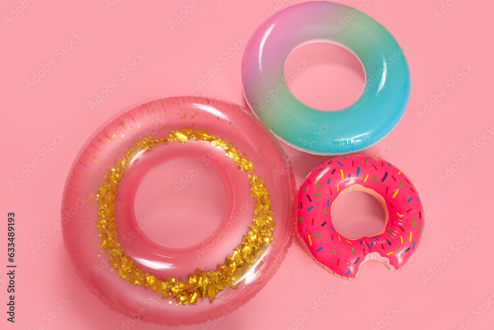 Inflatable rings on pink background