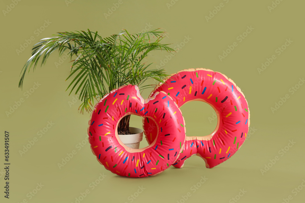 Swim rings with palm tree on green background