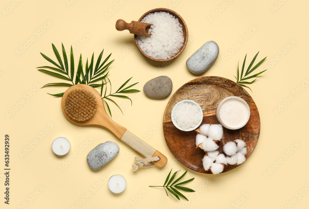 Composition with bath supplies, palm leaves and cotton flowers on color background