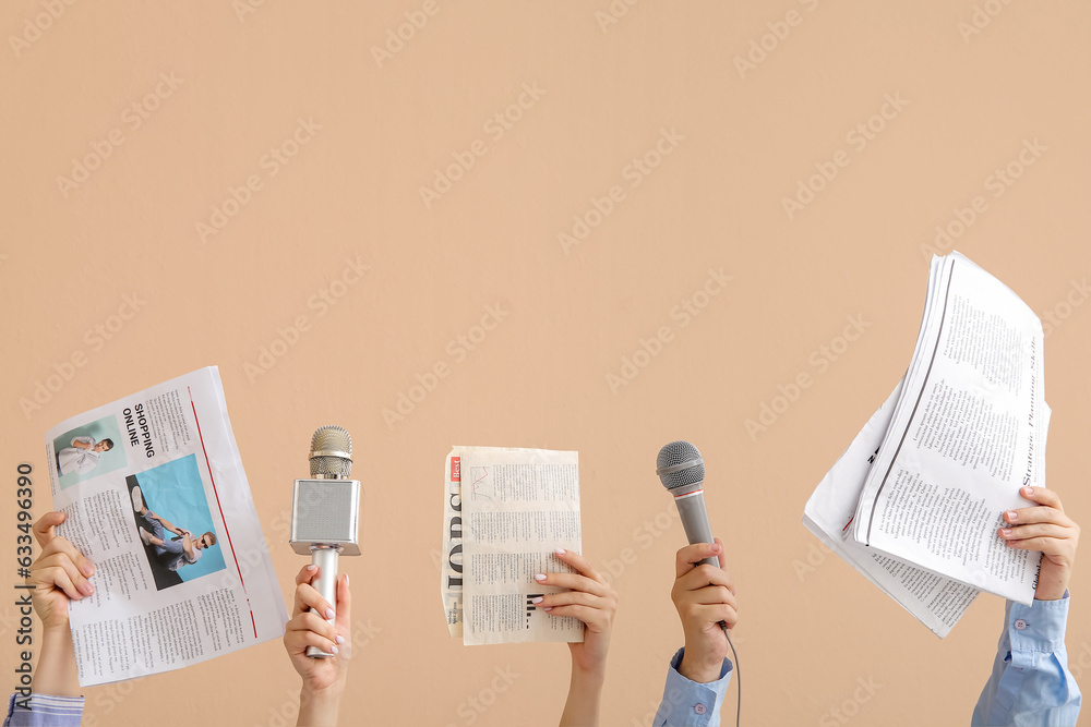 Female hands with microphones and newspapers on color background