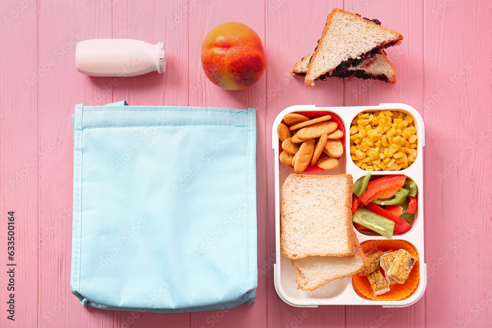 Bag, lunchbox with delicious food and drink on pink wooden background