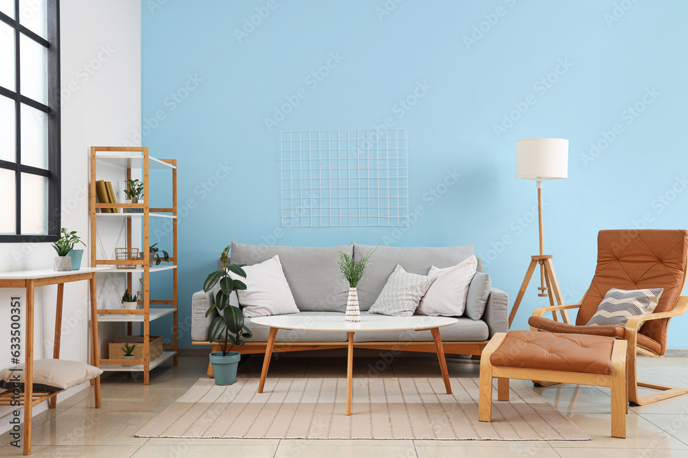 Interior of modern living room with comfortable armchair, sofa and table