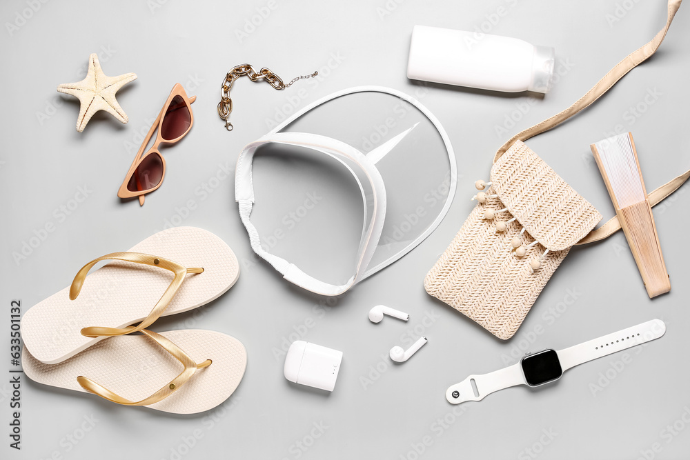 Composition with beach accessories and modern gadgets on grey background