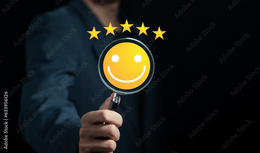 hand holding a magnifying glass with smiley face icon, customer service 5 star satisfaction experien