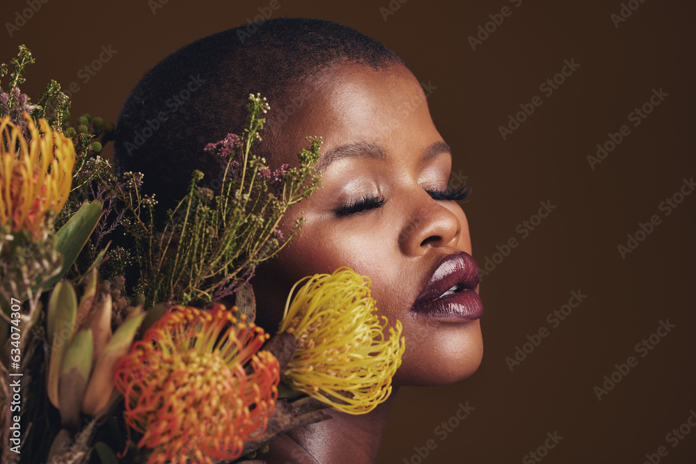 Black woman, flowers and makeup in studio for beauty, wellness or thinking with protea by brown back