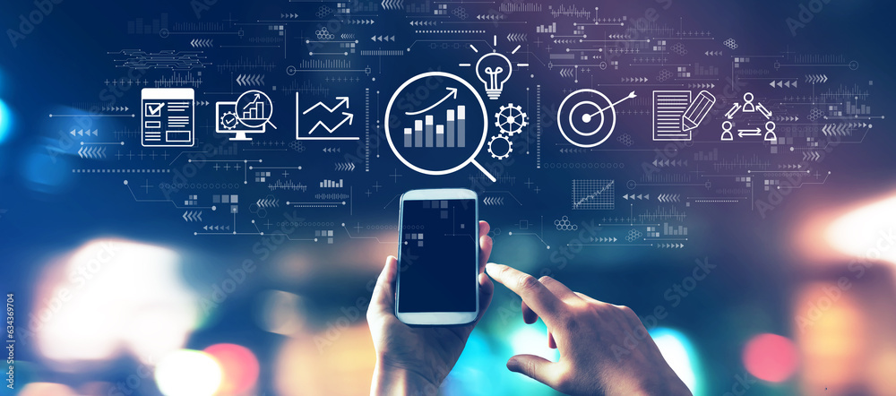 Data Analysis concept with a smartphone in blurred city lights at night