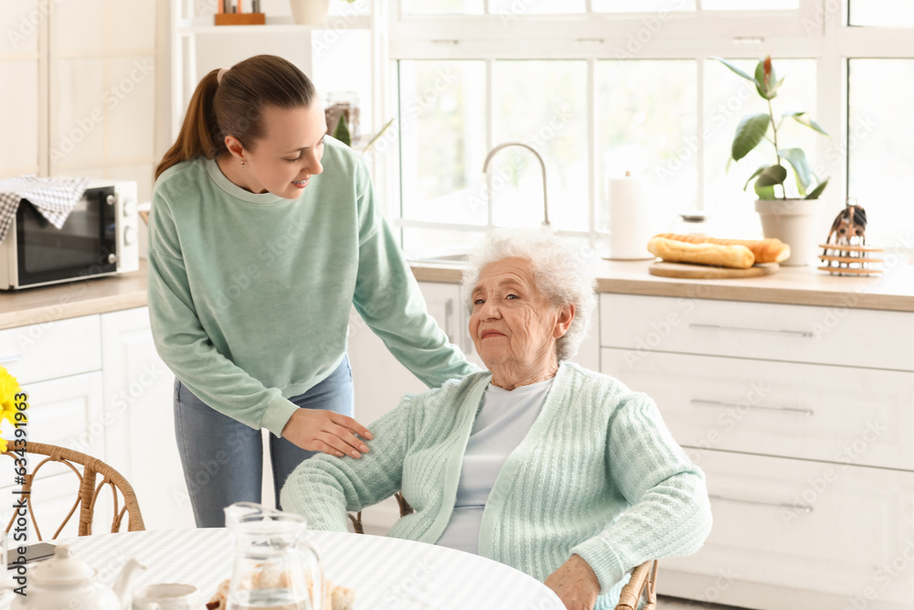 Senior woman with her granddaughter in kitchen