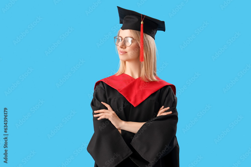 Female graduate student with diploma on blue background