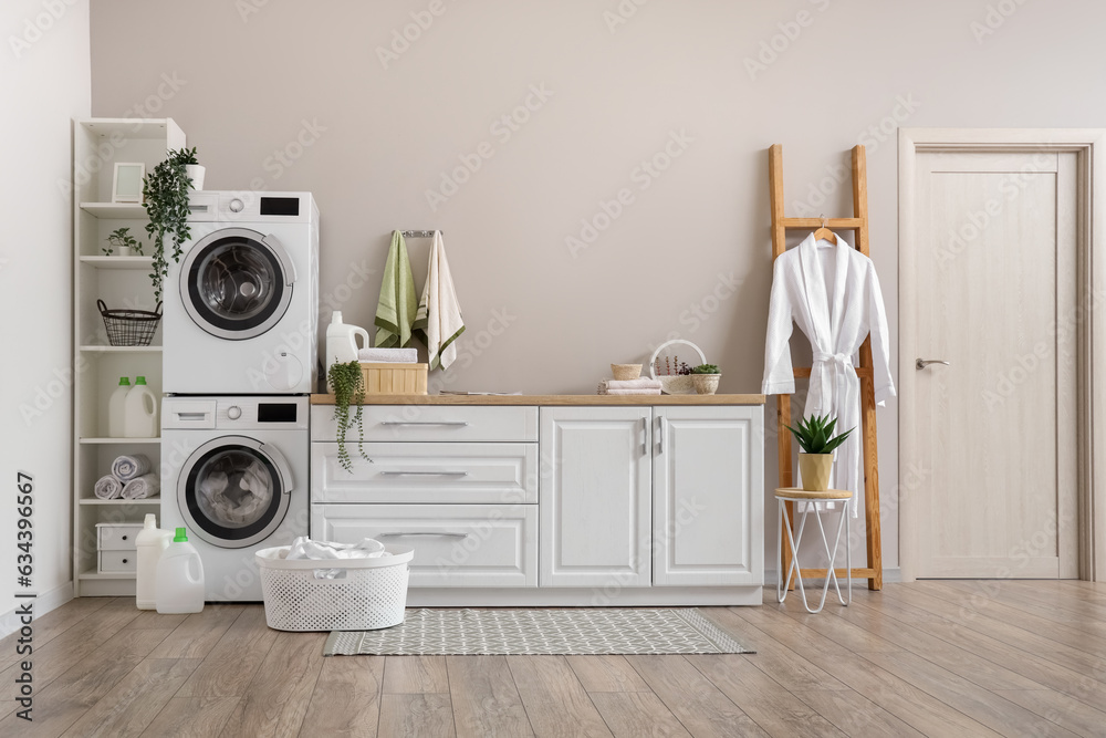 Laundry room with washing machines and white counters