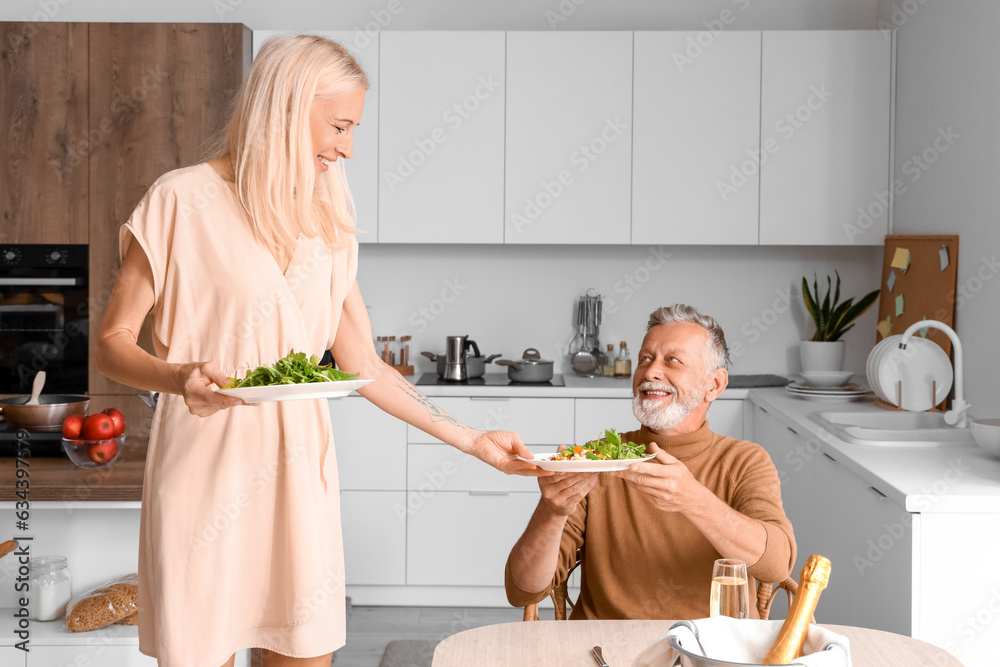 Mature couple having dinner in kitchen