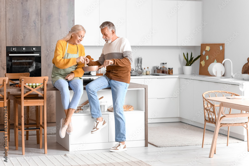 Mature couple eating in kitchen