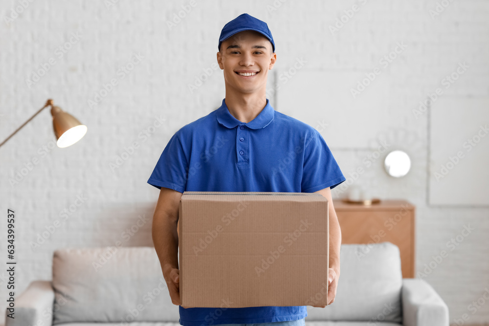 Young courier with parcel in room