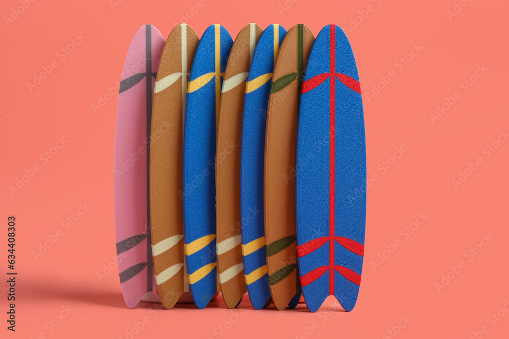 Different mini surfboards on pink background