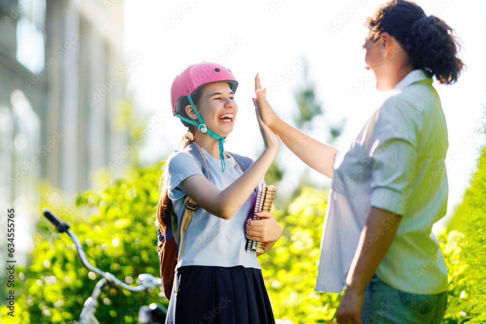 Girl in safety helmet with mother