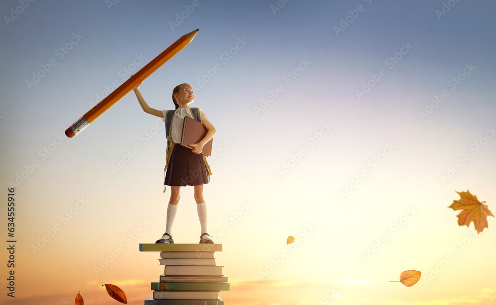 child on the tower of books