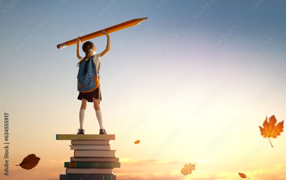 child on the tower of books