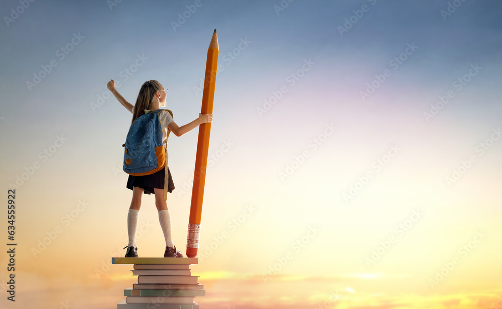 child on the tower of books