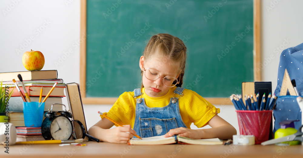 Thinking child is sitting at desk