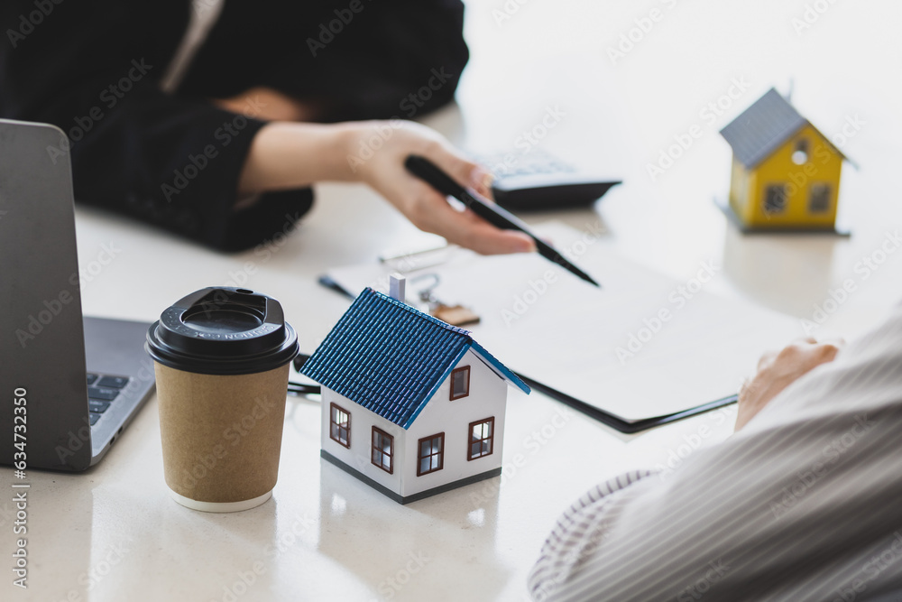 Businesswoman, real estate agent discussing the terms of the house purchase agreement contract docum