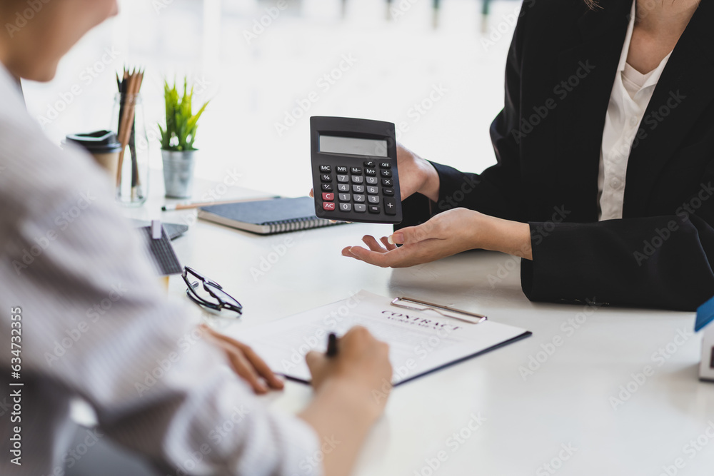 Businesswoman, real estate agent discussing the terms of the house purchase agreement contract docum