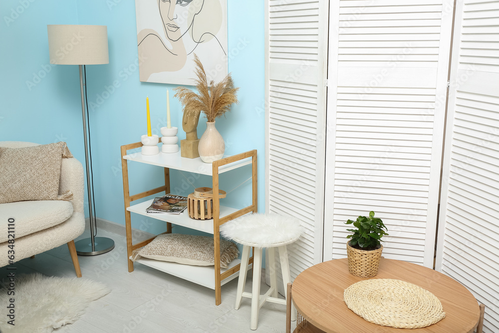 Modern living room interior with shelving unit, coffee table and folding screen