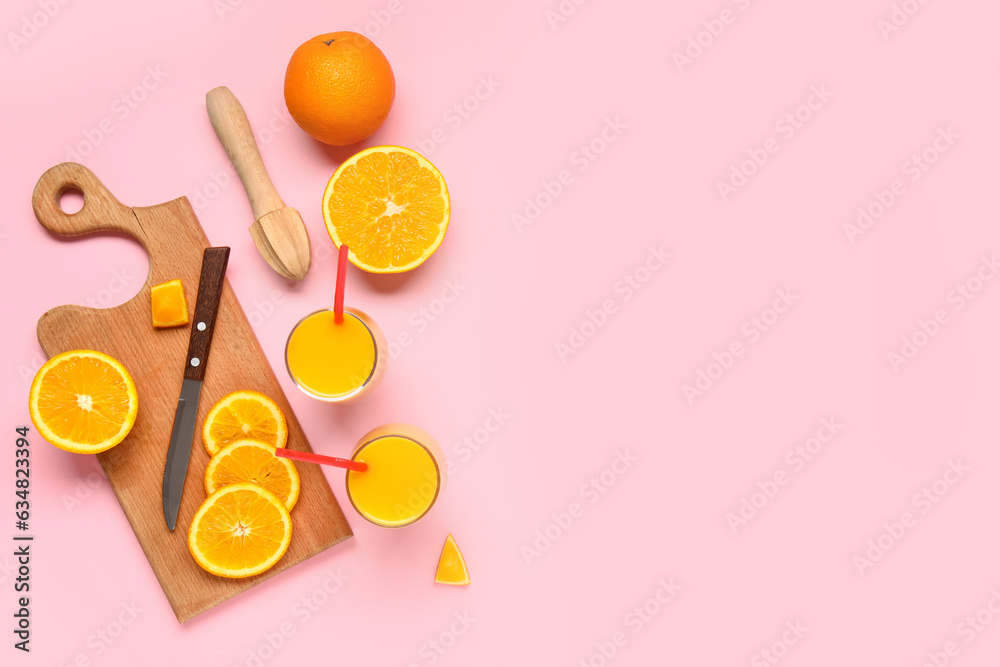 Glasses of fresh orange juice and wooden juicer on pink background